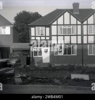 1961, historical, a recently built 'mock-tudor' semi-detached house on a new modern housing estate in Essex, England, UK, car of the era parked in the  driveway. Stock Photo