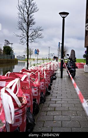 Sandbags and big bags on the sidewalk protect the houses in the street against flooding due to the high water level of the Markermeer lake in Hoorn Stock Photo