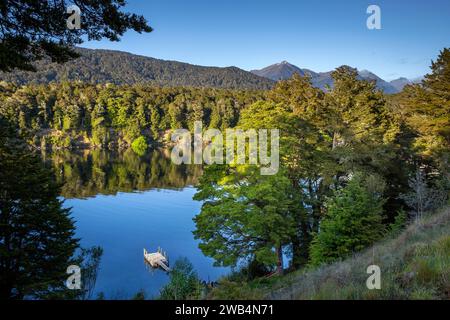 Floating dock and the calm waters of Pearl Harbor on the Waiau River at Manapouri, Aotearoa (New Zealand), Waipounamu (South Island) Stock Photo