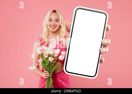 Pretty european lady enjoying bouquet of flowers show phone Stock Photo