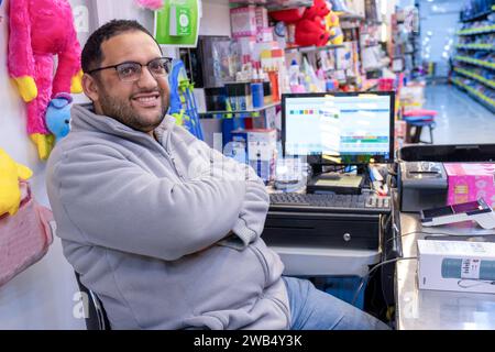 portrait for school shop owner sitting at the cashier chair Stock Photo