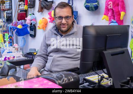 portrait for school shop owner sitting at the cashier chair Stock Photo