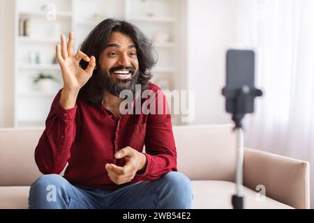 Cool indian guy influencer streaming from home Stock Photo