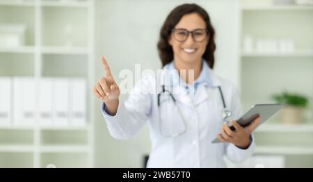 Woman doctor with digital tablet in her hand touching screen Stock Photo