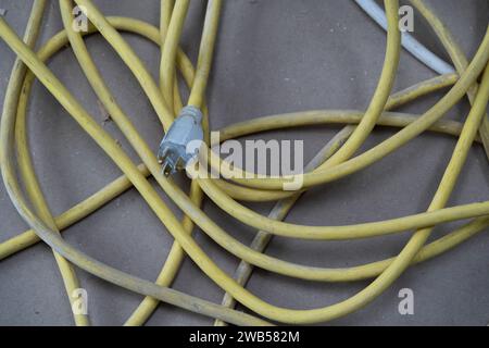 Yellow extension cord on floor at home construction job site. Stock Photo