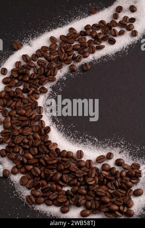 In this close-up photo, a group of coffee beans creates a textured background, emanating the rich aroma of caffeine. With copy space, the image emphas Stock Photo