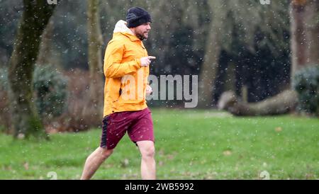 London, UK. 8th Jan, 2024. A man jogs in snow in London, Britain, on Jan. 8, 2024. Credit: Xinhua/Alamy Live News Stock Photo