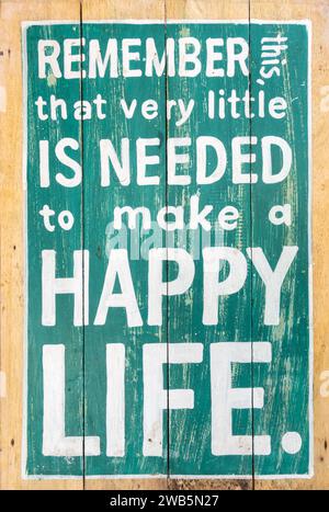 Remember that very little is needed to make a happy life wooden plate Stock Photo