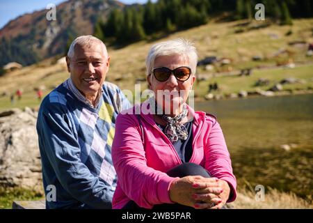 Elderly couple finding solace and joy as they rest on a park bench, engaged in heartfelt conversation, following a rejuvenating strol a testament to Stock Photo