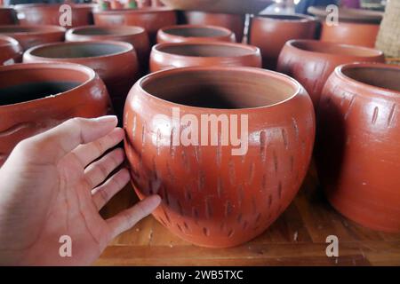 Handmade ceramic clay terracotta jugs, pots, vases, souvenirs on shelves in street craft pottery shop. Clay brown ceramic pot jug Stock Photo