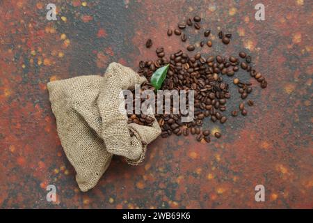Sack bag with coffee beans on grunge background Stock Photo