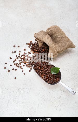 Sack bag and scoop with coffee beans on light background Stock Photo