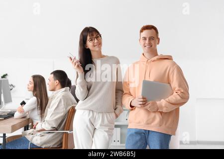 Team of young programmers with gadgets in office Stock Photo