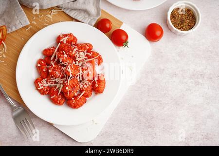 Plate of tasty gnocchi with cheese on table Stock Photo