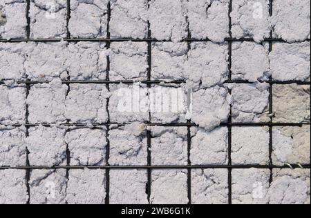 Texture of Handmade Paper on a black metal grid. Stock Photo