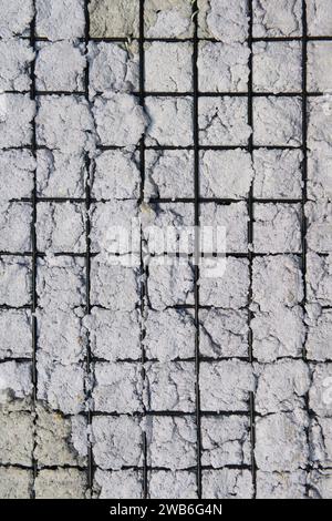 Texture of Handmade Paper on a black metal grid. Stock Photo