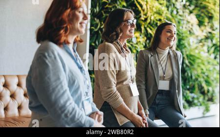 Diverse business professionals engage in a lively meeting in an office. Their teamwork and communication skills shine through as they discuss ideas an Stock Photo