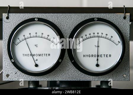 Thermometer with hygrometer manometer humidity and Temperature measurement on a industrial metal wall. Stock Photo