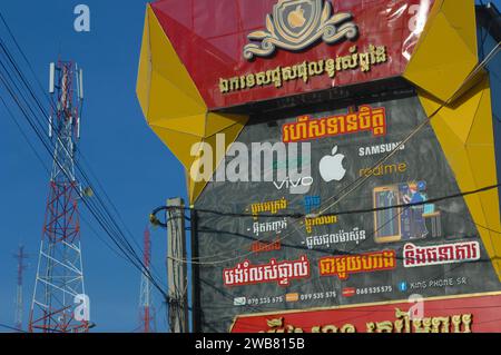 Telephone advertising and a telephone tower, Siem Reap, Cambodia. Stock Photo