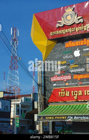 Telephone advertising and a telephone tower, Siem Reap, Cambodia. Stock Photo