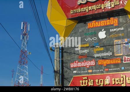 Telephone advertising and a telephone tower, Siem Reap, Cambodia. Stock Photo