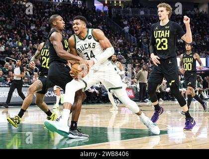 Milwaukee, USA. 9th Jan, 2024. Utah Jazz guard Kris Dunn (L) defends Milwaukee Bucks forward Giannis Antetokounmpo (C) during the NBA regular season game between Milwaukee Bucks and Utah Jazz in Milwaukee, the United States, Jan. 9, 2024. Credit: Joel Lerner/Xinhua/Alamy Live News Stock Photo