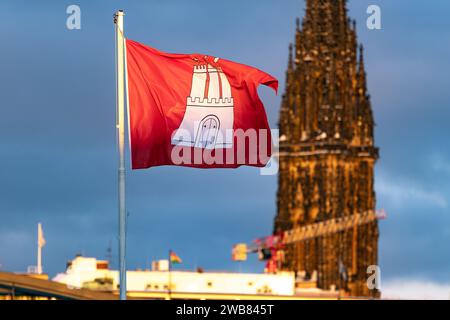 Hamburg flag in front of the tower of the Nikolai Church Stock Photo