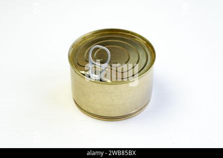 Unlabeled canned tuna on white background. A blank mockup tin-coated steel tuna can with open lid on white table. Canned fish steak and preserved food Stock Photo