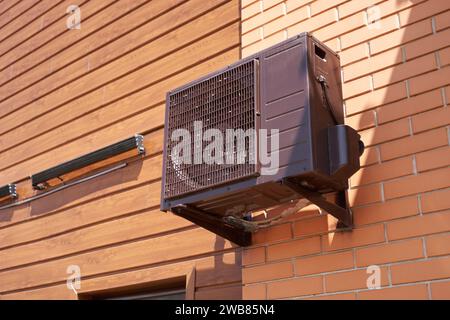 The air conditioner compressor is black on the wall of the building Stock Photo