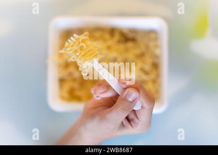 instant noodles brewed in boiling water on the table in the id on top. Stock Photo
