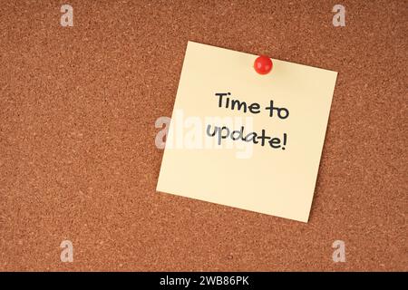 Time to update text on adhesive note Stock Photo