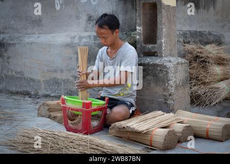 Man making incense sticks at Quang Phu Cau Incense Village  in Hanoi, Vietnam Stock Photo