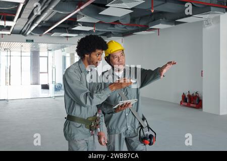 Construction workers discussing building renovation process Stock Photo