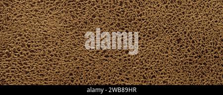 Dark brown background from a soft upholstery textile material, closeup. Matte bronze velvet fabric with natural texture. Cloth backdrop. Stock Photo