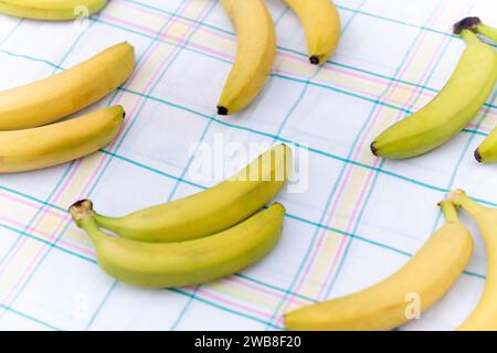 Multiple bananas over white cloth, above top view Stock Photo