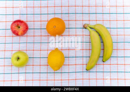 Tropical fruit mix on a table with white tablecloth. healthy food view from above, top view Stock Photo