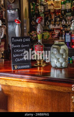 Mason jar filled with old fashioned pickled eggs in the Park Tavern family-owned freehouse in Kingston upon Thames. Stock Photo