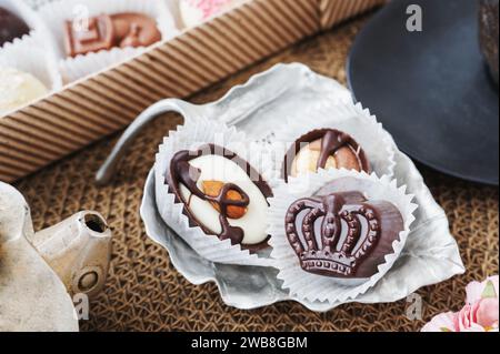 Handmade candies in the form of a crown close-up on the table. Festive still life of handmade chocolate. Stock Photo