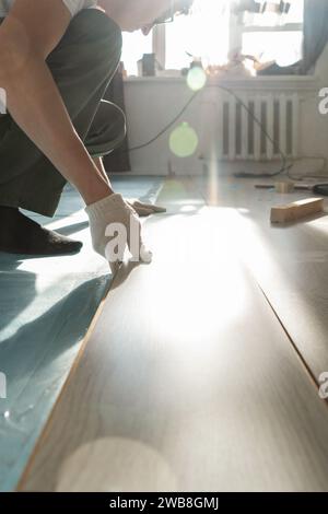 Man is repairing the floor in the house, laminate flooring Stock Photo