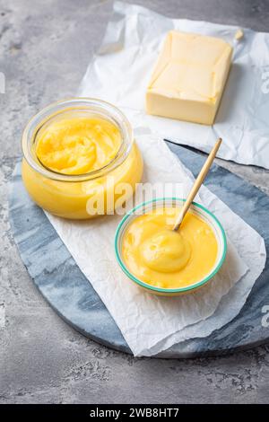 Ghee or clarified butter in jar and bowl. Indian butter. Stock Photo