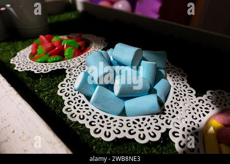 Colorful blue marshmallow candies on a plate, adding a sweet touch to a birthday celebration. Stock Photo