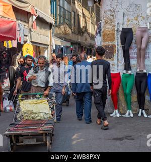 Porter pushes his unloaded cart along a narrow street in the Grand Bazaar area in Tehran, Iran. Stock Photo