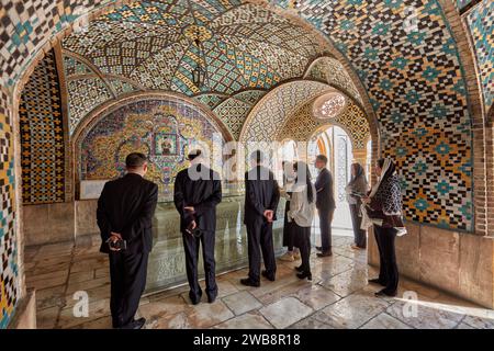 Group of visitors at the marble tombstone of Nasser ed Din Shah at the Karim Khani Nook, a structure in the Golestan Palace. Tehran, Iran. Stock Photo