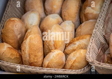 Close-up image of freshly baked bread rolls displayed in wicker baskets at a bakery or market in Altamura, Bari, Puglia, Italy Stock Photo