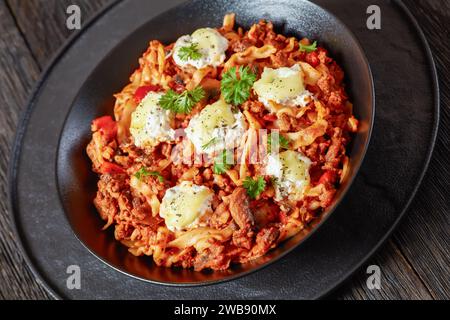 Lasagnette with beef ragu, mushrooms and ricotta cheese in white bowl ...