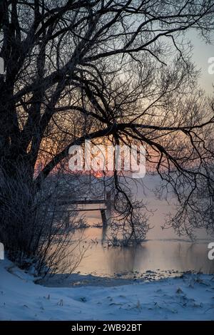 Sunrise over a lake on a cold icy winter morning, Waldviertel, Austria Stock Photo
