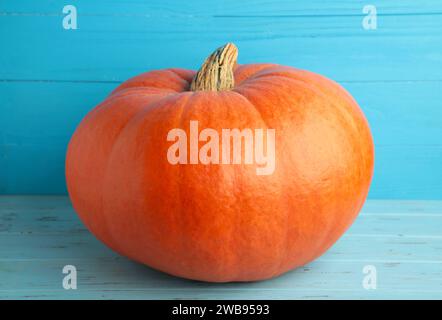Fresh orange pumpkin on blue background. Top view Stock Photo