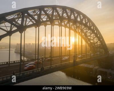 Foggy sun rise behind Tyne Bridge and Sage Centre, shot from a drone Stock Photo