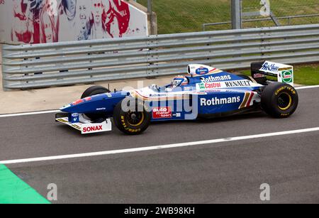 Ted Zorbas in Jacques Villeneuve's,  1997, Williams FW19 during the 75th Anniversary Demonstration of Grand prix at Silverstone. Stock Photo