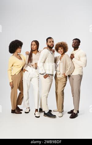 five african american people in casual outfits standing on grey background, Juneteenth concept Stock Photo